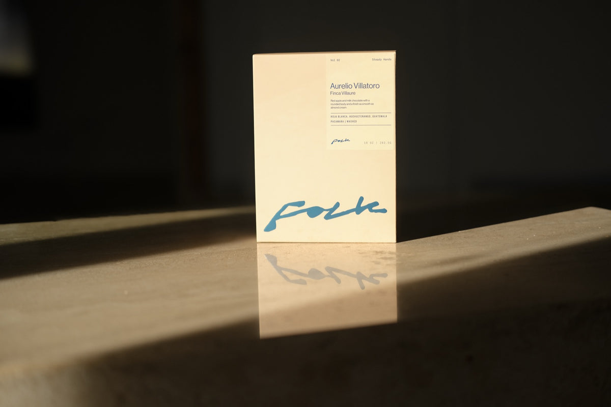 A Folk Volume box with its roast date printed on the label